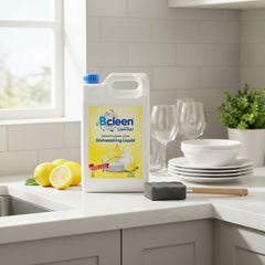 Bclean dishwashing liquid container on a kitchen counter with lemons and glasses.