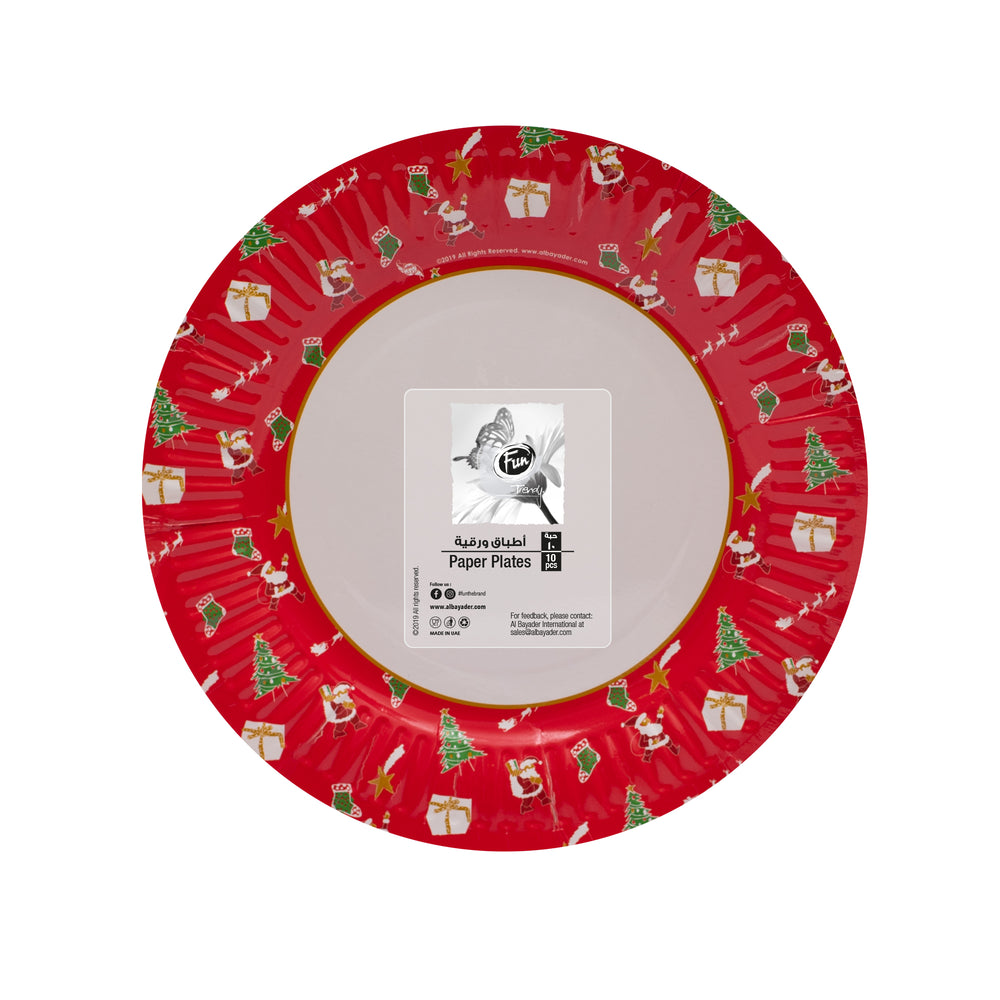 A red paper plate with Christmas-themed patterns including trees and presents.