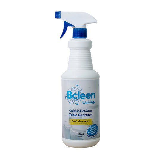 A 900ml spray bottle of Bcleen Table Sanitizer with a white body and blue spray nozzle. The label on the bottle indicates that it is a 'Crystal clear' table sanitizer.