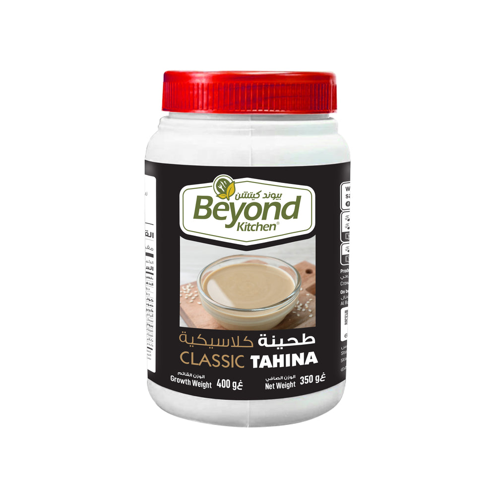 Jar of Beyond Kitchen Tahina with a red lid on a white background