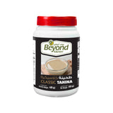 Jar of Beyond Kitchen Tahina with a red lid on a white background