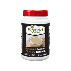 Jar of Beyond Kitchen Tahina with a red lid on a white background