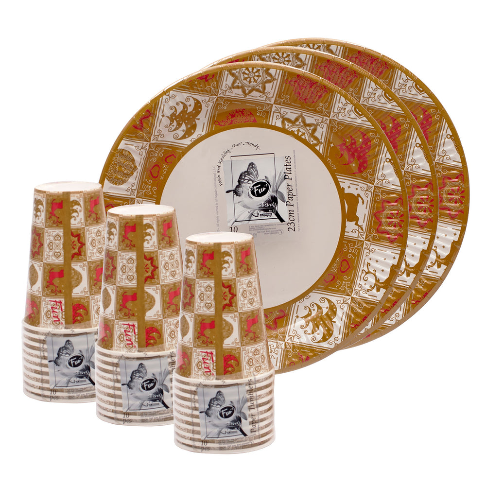 A set of paper plates and paper cups with a festive Christmas tree pattern.